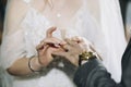 Bride puts a wedding gold ring on groom& x27;s finger in church during the wedding ceremony Royalty Free Stock Photo