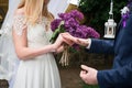 Bride puts wedding ring on grooms finger. Bride and groom exchange rings in wedding day. Wedding ceremony process. Marriage engage Royalty Free Stock Photo