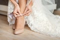 Bride puts on wedding shoes