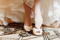 Bride puts on white shoes