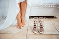 Bride is putting on her shoes for the wedding day Royalty Free Stock Photo