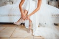 Bride is putting on her shoes for the wedding day Royalty Free Stock Photo