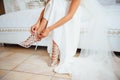Bride is putting on her shoes for the wedding day Royalty Free Stock Photo