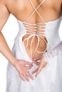 Bride putting on her white wedding dress, closeup hands and lace dress. young woman tying up her wedding dress Royalty Free Stock Photo