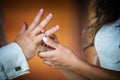 Bride putting ring on groom`s finger