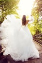 Bride Rear View, Happy Woman in Elegant Wedding Dress walking in Summer Park