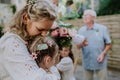 Bride receiving congratulations by little girls at outdoor wedding party. Royalty Free Stock Photo