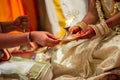 Bride receiving lamp from priest at a Tamil Hindu wedding