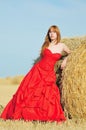 Bride in red wedding dress in a field Royalty Free Stock Photo