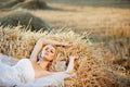 Bride resting in hay stack Royalty Free Stock Photo