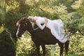 Bride riding on horse.