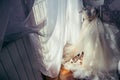 Bride Room Horizontal Fashionable Long Wedding Dress Flowers Beige High Heels Hanging Chair Window Sunshine.