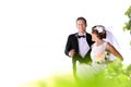 Bride running away from groom for fun Royalty Free Stock Photo