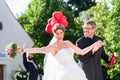 Bride running away with priest after wedding Royalty Free Stock Photo