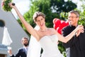 Bride running away with priest after wedding Royalty Free Stock Photo