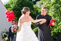 Bride running away with priest after wedding Royalty Free Stock Photo