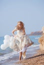 Bride running on beach