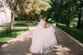 The bride is running playfully along the alley of stones. The girl in the wedding dress is having fun and running away Royalty Free Stock Photo