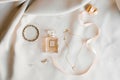 Bride`s accessories: eau de toilette, earrings, pendant and bracelet Royalty Free Stock Photo