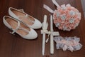 Bride's accessories. Women's shoes leather, garter, bridal bouquet, candles, pendant Royalty Free Stock Photo