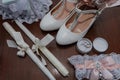 Bride's accessories. Women's shoes leather, garter, bridal bouquet, candles, pendant Royalty Free Stock Photo