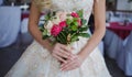 Bride`s bouquet. Beautiful girl in a luxurious wedding dress holding flowers Royalty Free Stock Photo