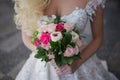 Bride`s bouquet. Beautiful girl in a luxurious wedding dress holding flowers Royalty Free Stock Photo