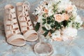 Bride`s bouquet, beige shoes, wedding rings and perfume. The bride`s accessories Royalty Free Stock Photo