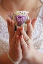 The bride`s bouquet of purple, pink and white flowers. Bouquet of purple and pink roses. White roses. The bride holds a boutonnier