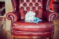 Bride's bouquet on a red armchair Royalty Free Stock Photo