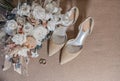 bride`s bouquet, shoes, wedding rings and a set of invitations. The bride`s accessories. Wedding morning