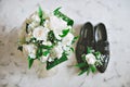 Bride's bouquets and shoes groom