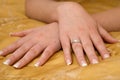 Bride's crossed hands showing a wedding ring Royalty Free Stock Photo