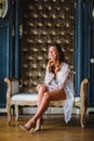 Young beautiful bride in white negligee preparing to wedding ceremony Royalty Free Stock Photo