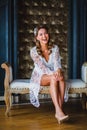 Young beautiful bride in white negligee preparing to wedding ceremony Royalty Free Stock Photo