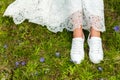 Bride`s feet in sneakers