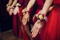 Bride`s friends show each other manicure. Green dresses. concept wedding, friendship and fashion. Girlfriends show off