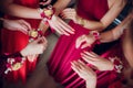 Bride`s friends show each other manicure. Green dresses. concept wedding, friendship and fashion. Girlfriends show off