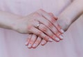 Bride`s hand with an elegant wedding ring with white gold diamonds on a bouquet of their peonies Royalty Free Stock Photo