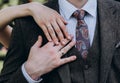 Bride`s hand with an elegant wedding ring with white gold diamonds on a bouquet of their peonies Royalty Free Stock Photo