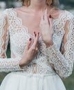 Bride`s hand with an elegant wedding ring with white gold diamonds on a bouquet of their peonies Royalty Free Stock Photo