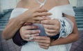 Bride`s hand with an elegant wedding ring with white gold diamonds on a bouquet of their peonies Royalty Free Stock Photo