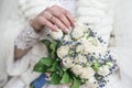 The bride\'s hand rests on a wedding bouquet made of white roses Royalty Free Stock Photo