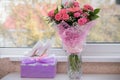 Bride`s shoes and bouquet near window Royalty Free Stock Photo