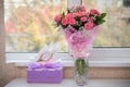 Bride`s shoes and bouquet near window Royalty Free Stock Photo