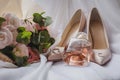 Bride`s shoes with a wedding bouquet and perfume on the veil. Wedding Concept Royalty Free Stock Photo