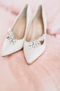 Bride`s shoes for the wedding day on bed sheet Royalty Free Stock Photo