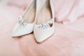 Bride`s shoes for the wedding day on bed sheet Royalty Free Stock Photo