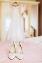 Bride`s shoes for the wedding day on bed sheet Royalty Free Stock Photo