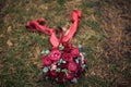 BrideÃ¢â¬â¢s wedding bouquet, red flowers on grass background Royalty Free Stock Photo